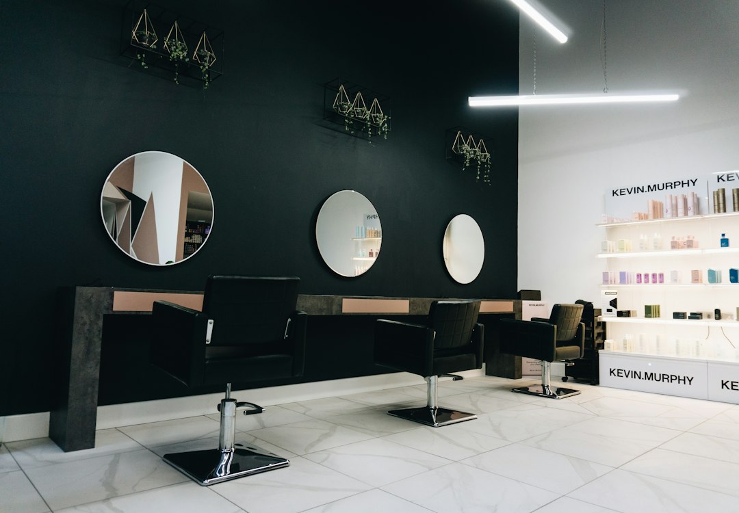 Hair salon with styling chairs, mirrors and a retail product display
