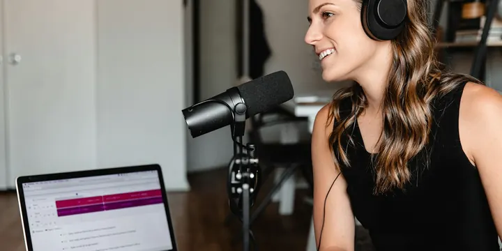 Podcaster recording with headphones and a microphone